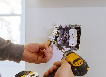 Electrician installing new electrical outlet Electrician installing new electrical outlet